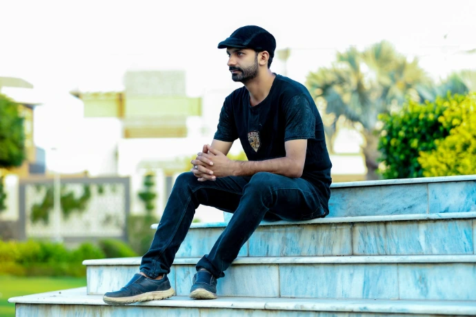 a man is sitting on a set of stairs